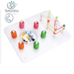 Colorful bead threading toy with plastic pegs and rubber bands on white base for laparoscopic training module peg transfer