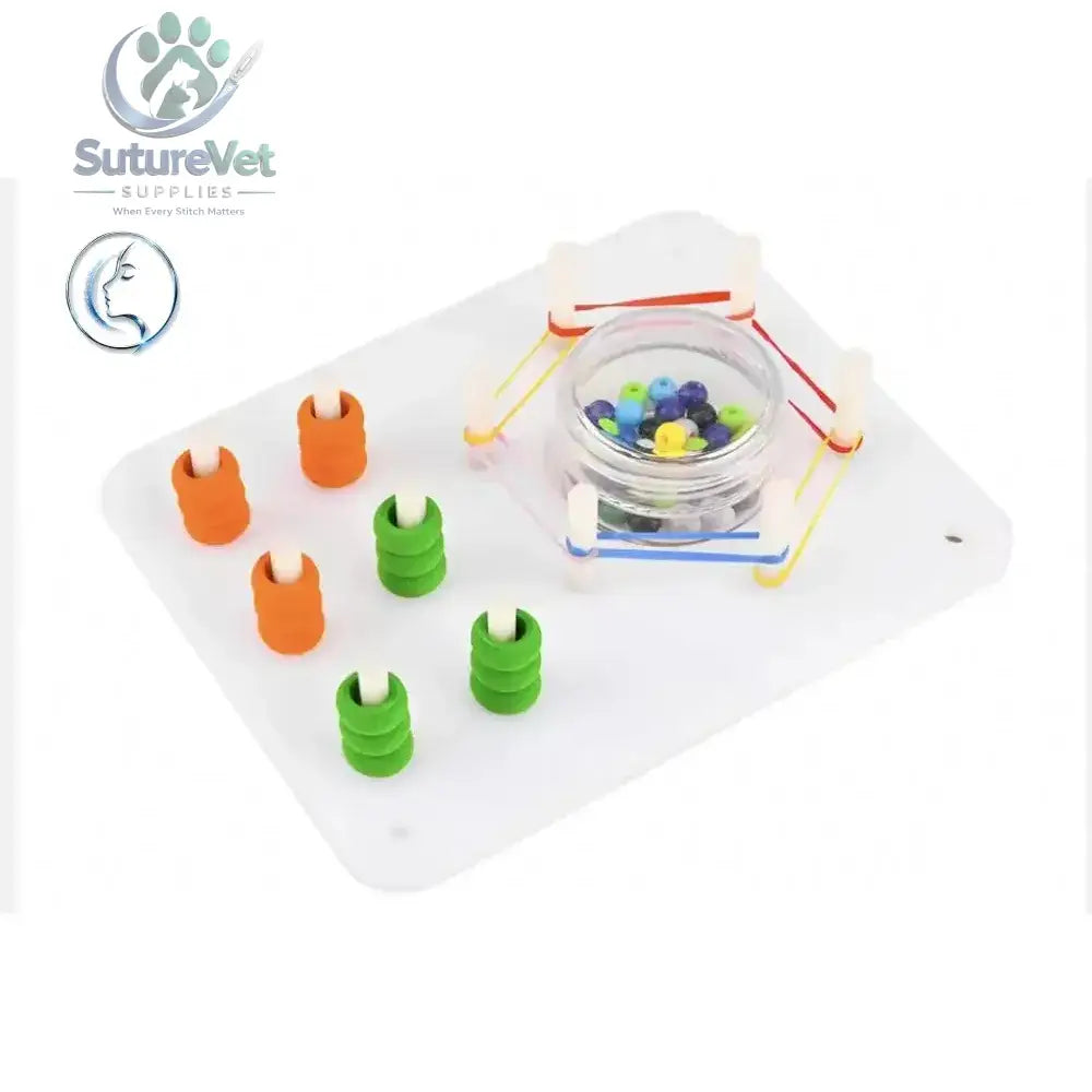 White plastic laparoscopic training module with orange green rings and colorful beads for peg transfer practice